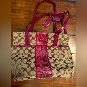 Pink and tan snake skin Coach purse.